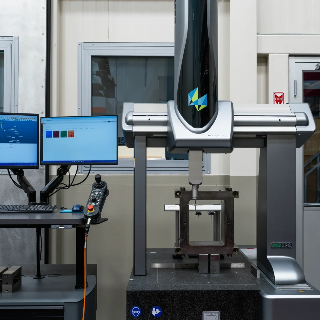 A machine in operation, fabricating a metal part with visible tools and components engaged in the manufacturing process.